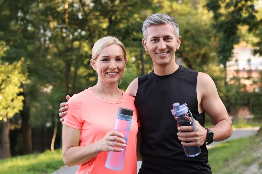 Active mature couple smiling together after an outdoor workout