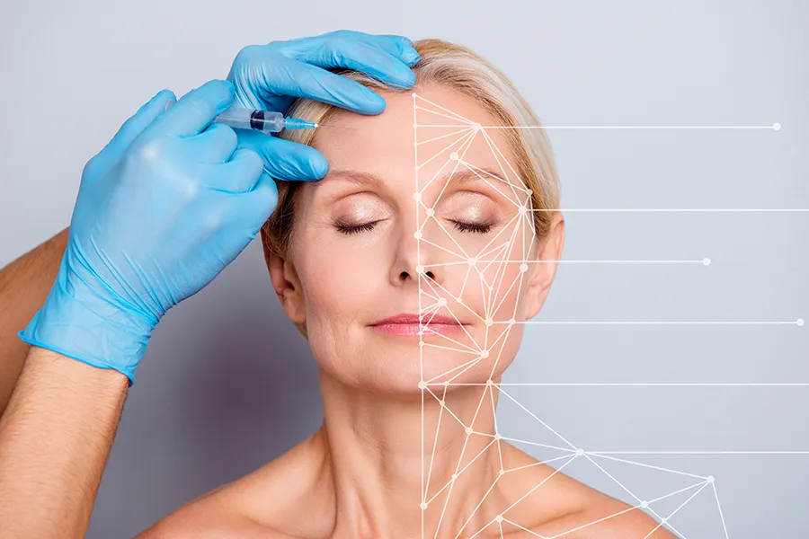 Aesthetic-Injectables-Clinic A mature blonde woman gets a facial injection. Get injectable aesthetic treatments from Blessed Beauty Boutique in Greater Phoenix.