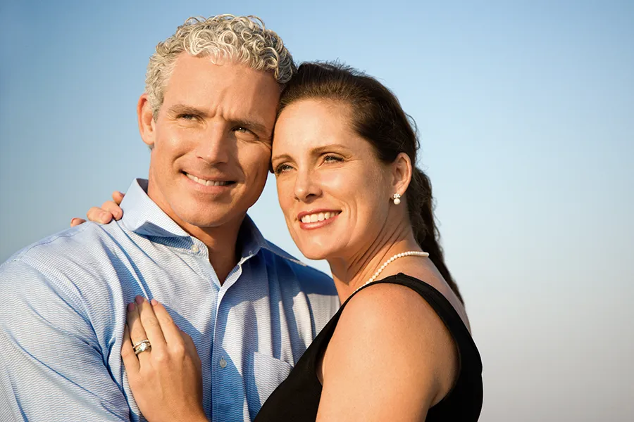 Healthy-Aging-Peptides-Doctor A middle-aged caucasian couple embraces in the sunshine, happy with the healthy aging peptide treatments from Blessed Beauty Boutique in Greater Phoenix