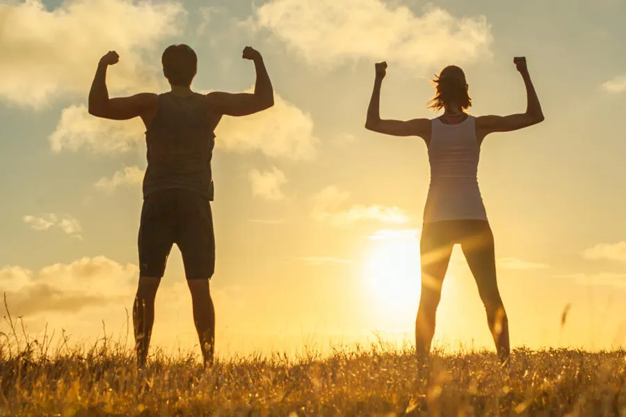 Immune-Optimization-Peptides-Clinic A couple flex their arms outside in the sunrise. Schedule Immune Optimization Peptide Treatment from Blessed Beauty Boutique in Greater Phoenix.