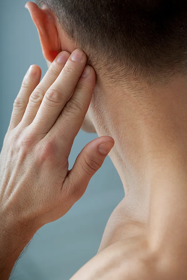 Lymphatic-Drainage-Massage-Treatment A man touching his lymph nodes. Get Lymphatic Drainage Massage from Blessed Beauty Boutique in Greater Phoenix.