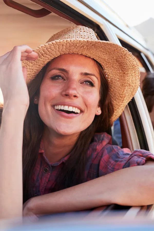 Microdermabrasion-Treatment A woman with long brown hair wearing a sunhat and smiling. Get microdermabrasion treatment from Blessed Beauty Boutique in Greater Phoenix.