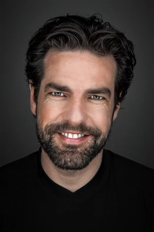 PRF-for-Hair-Restoration-Treatment A smiling man with full dark hair and a beard. Get PRF therapy for hair restoration from Blessed Beauty Boutique in Greater Phoenix.