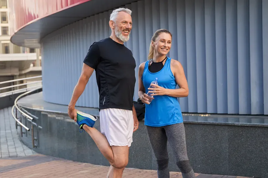 Peptides-for-Healing-and-Recovery-Doctor A middle-aged couple happily stretch and prepare for exercise after receiving effective peptide therapy for healing and recovery from Blessed Beauty Boutique in Greater Phoenix.