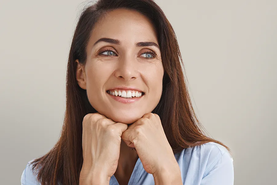 Xeomin-Facial-Injections-Clinic A woman with long brown hair and smooth radiant skin. Schedule Xeomin Facial Injections from Blessed Beauty Boutique in Greater Phoenix.